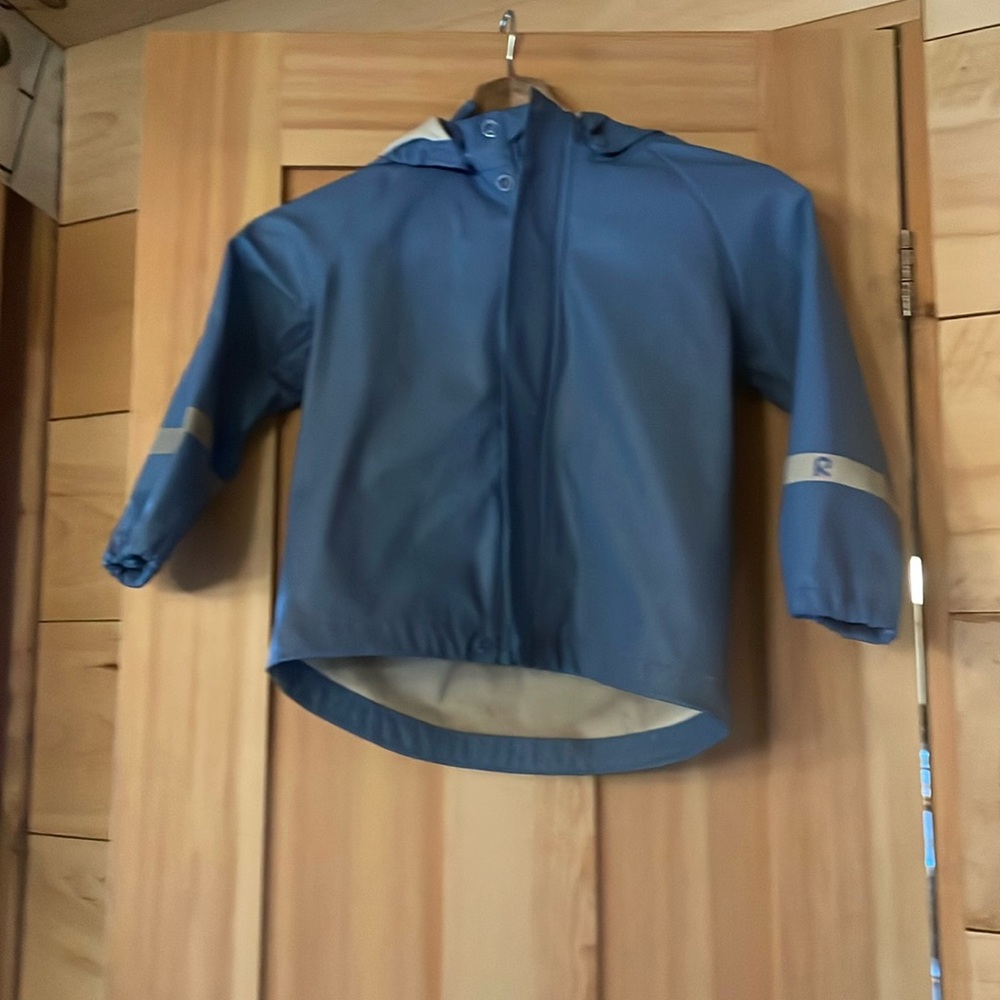 Reima 3T periwinkle rain jacket with reflective details.